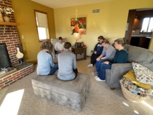 A group of moms praying together in a home